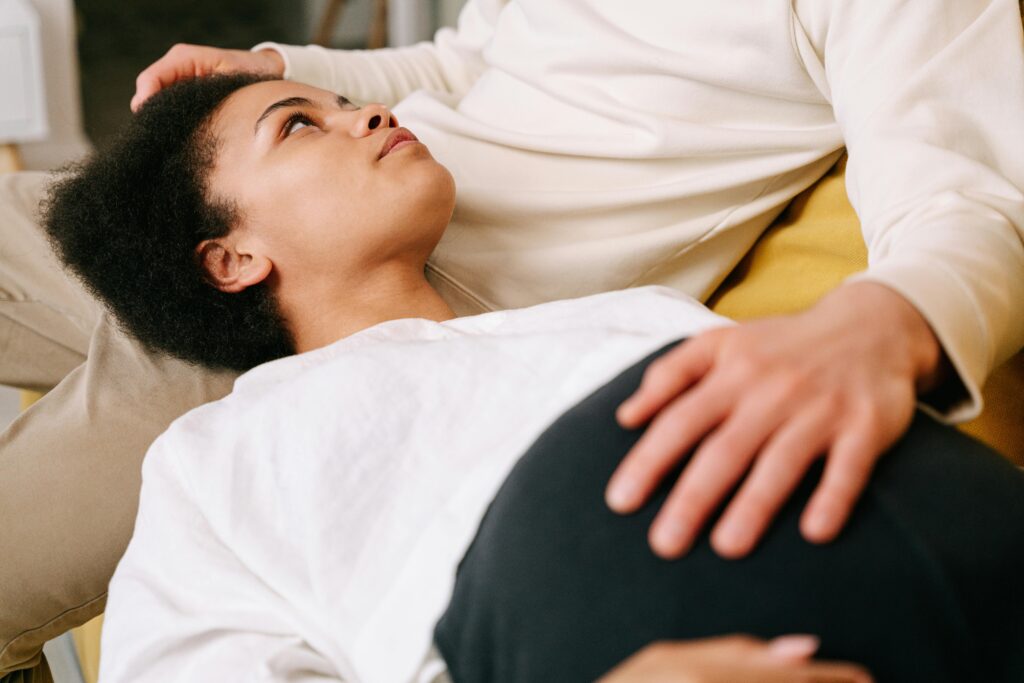 Expectant couple sharing a tender moment with focus on pregnancy and emotional connection.