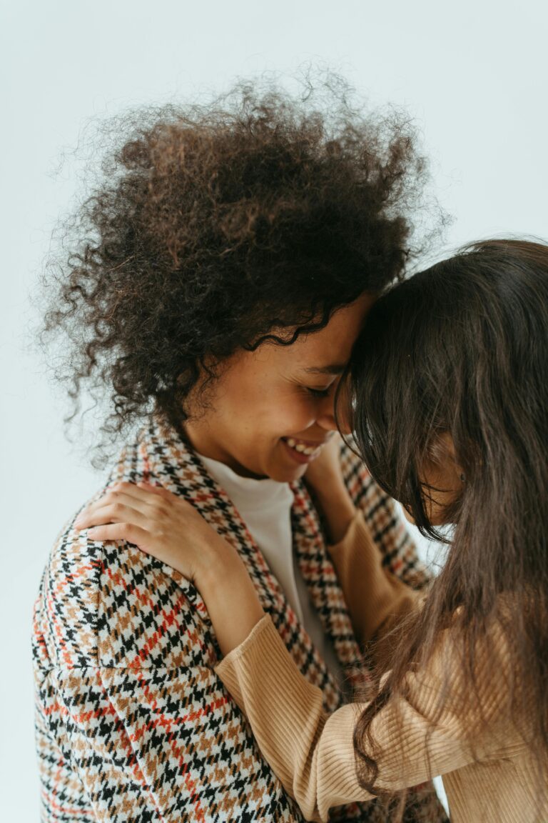 A loving embrace between a mother and daughter, sharing a joyful and intimate moment.