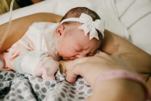 A touching scene of a newborn baby breastfeeding, symbolizing innocence and motherhood.